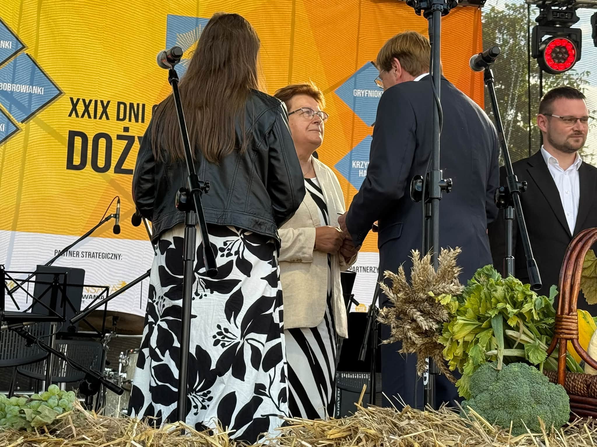 Osoby gratulujące sobie na scenie 