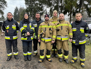 strażacy pozujacy do zdjęcie