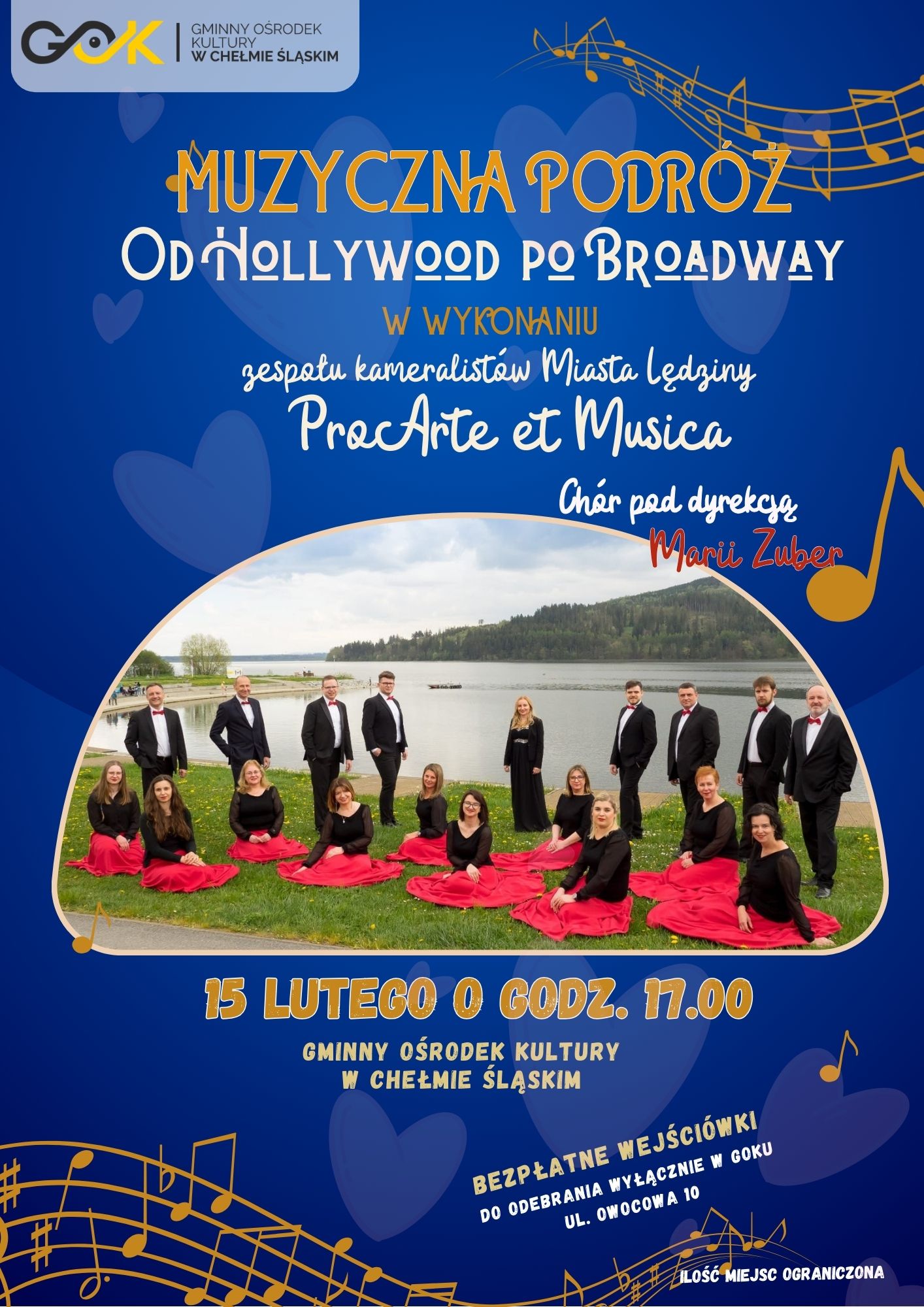 Plakat promujący wydarzenie - na zdjęciu kobiety siedzące w czerwonych pieknych koncertowych spódnicach na trawie i stojący przy nich mężczyźni w garniturach. W tle jezioro